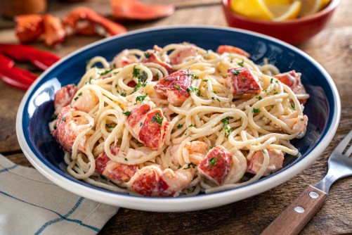 A,Plate,Of,Delicious,Lobster,Pasta,On,A,Rustic,Wood